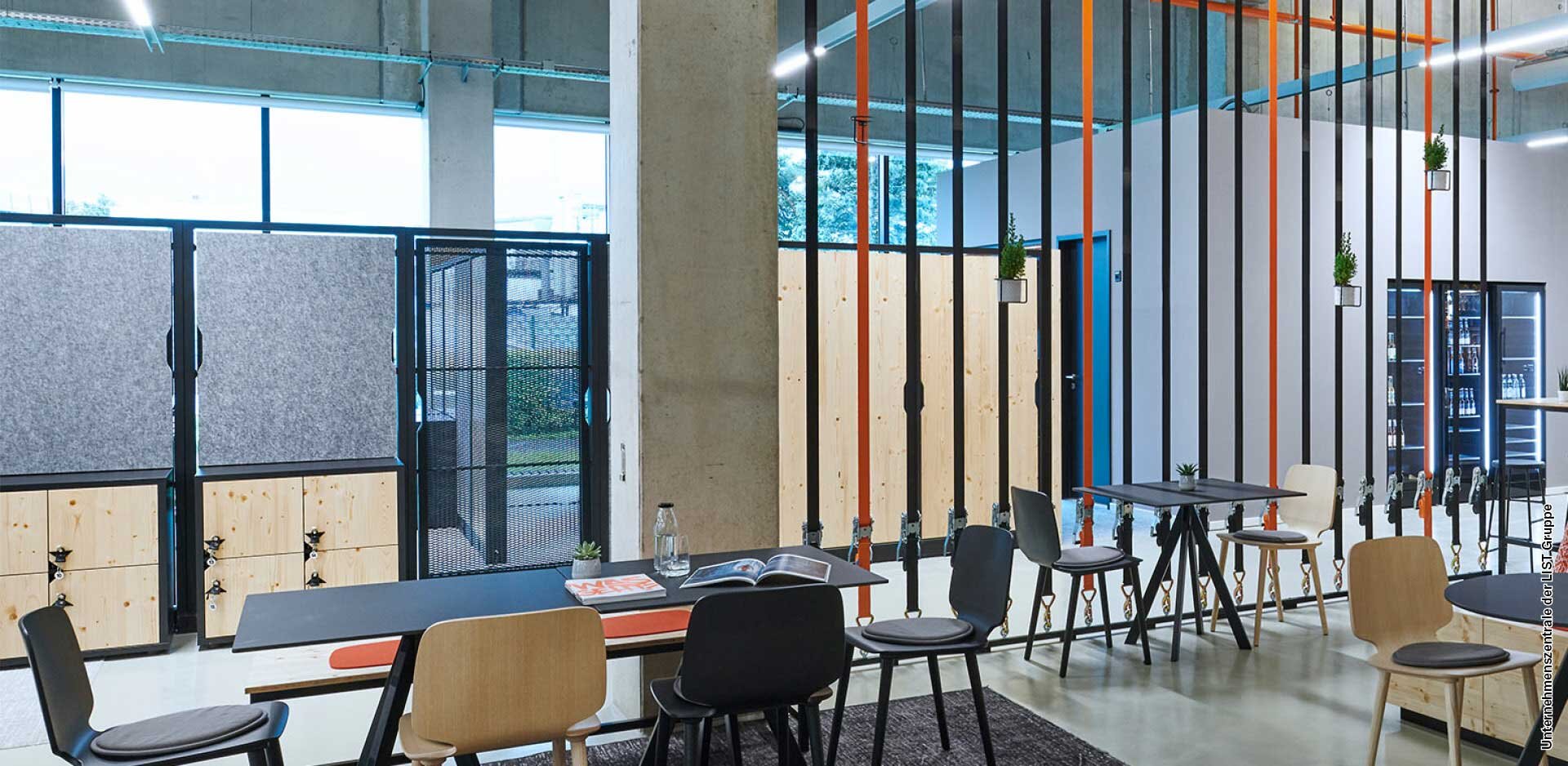 An office dining area featuring tables, chairs and sound-absorbing panels.