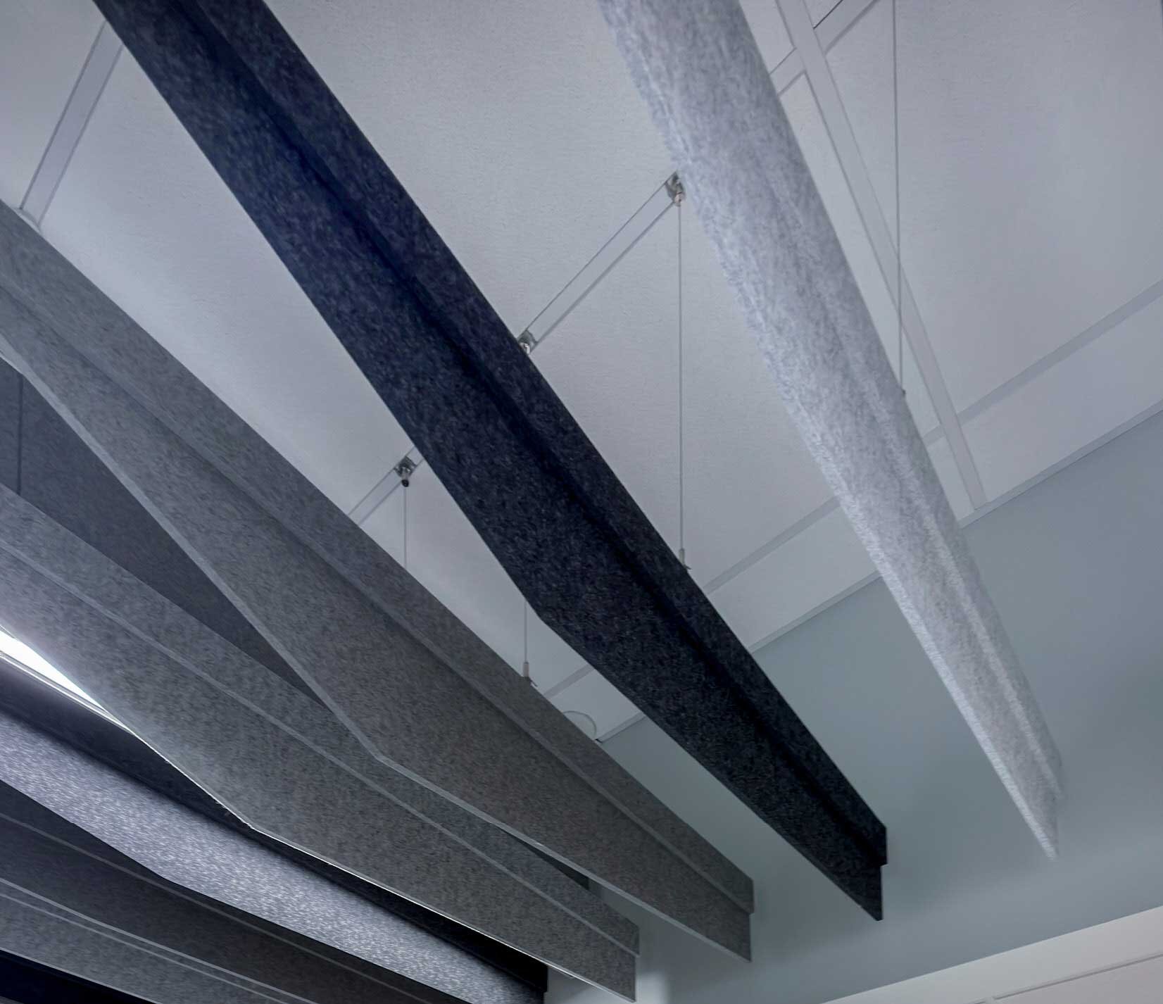 Sound-absorbing panels hanging from a ceiling