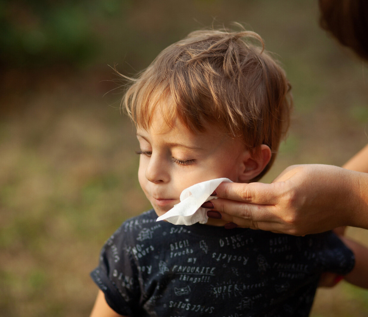 Boy wipes face with cloth | Sandler Group