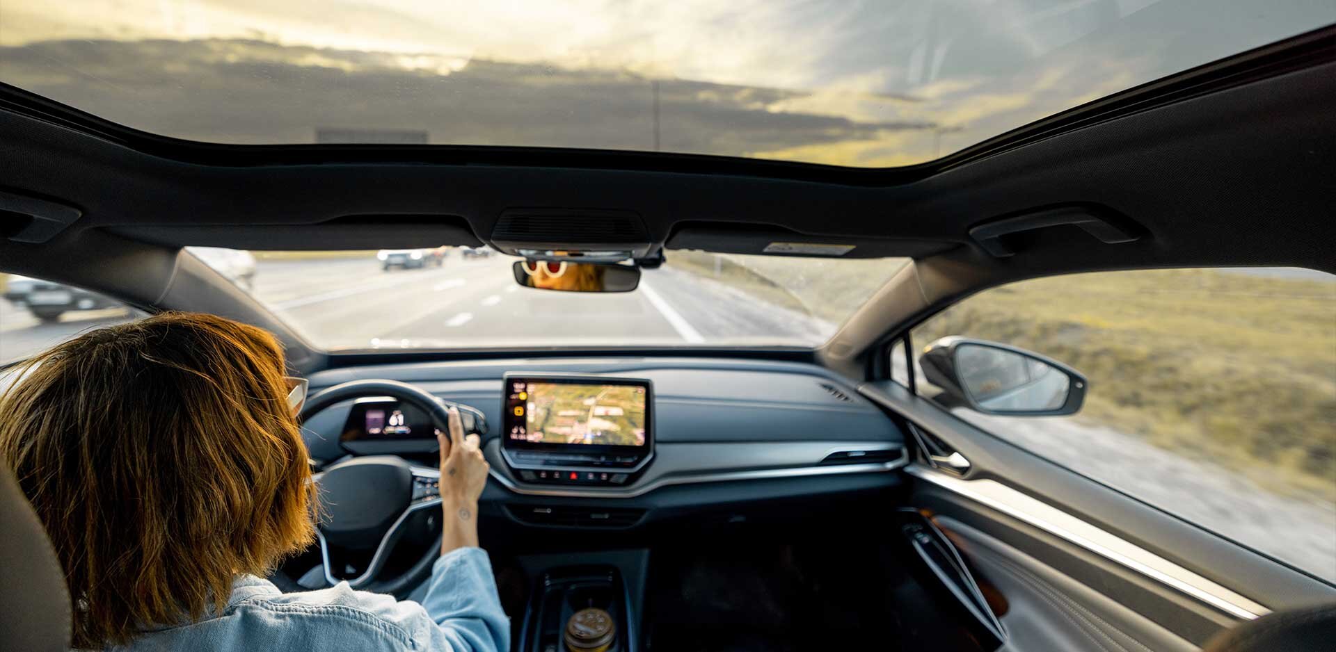 Woman drives car with panoramic rooftop | Sandler Group