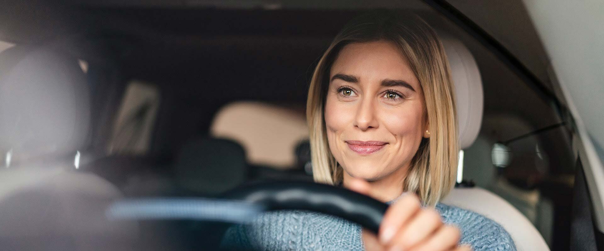Female driver at the wheel | Sandler Group 