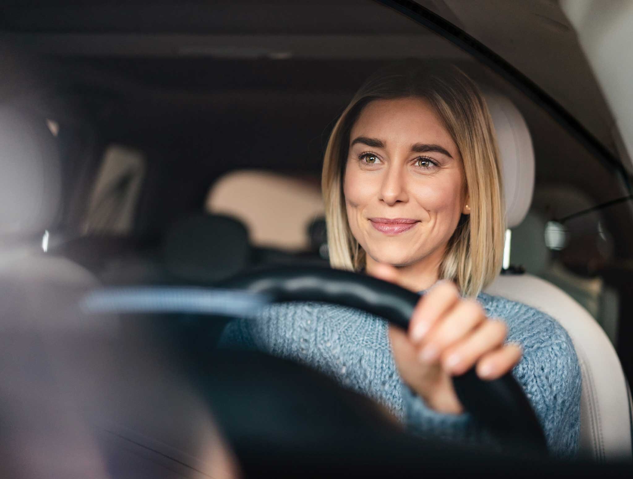 Female driver at the wheel | Sandler Group 