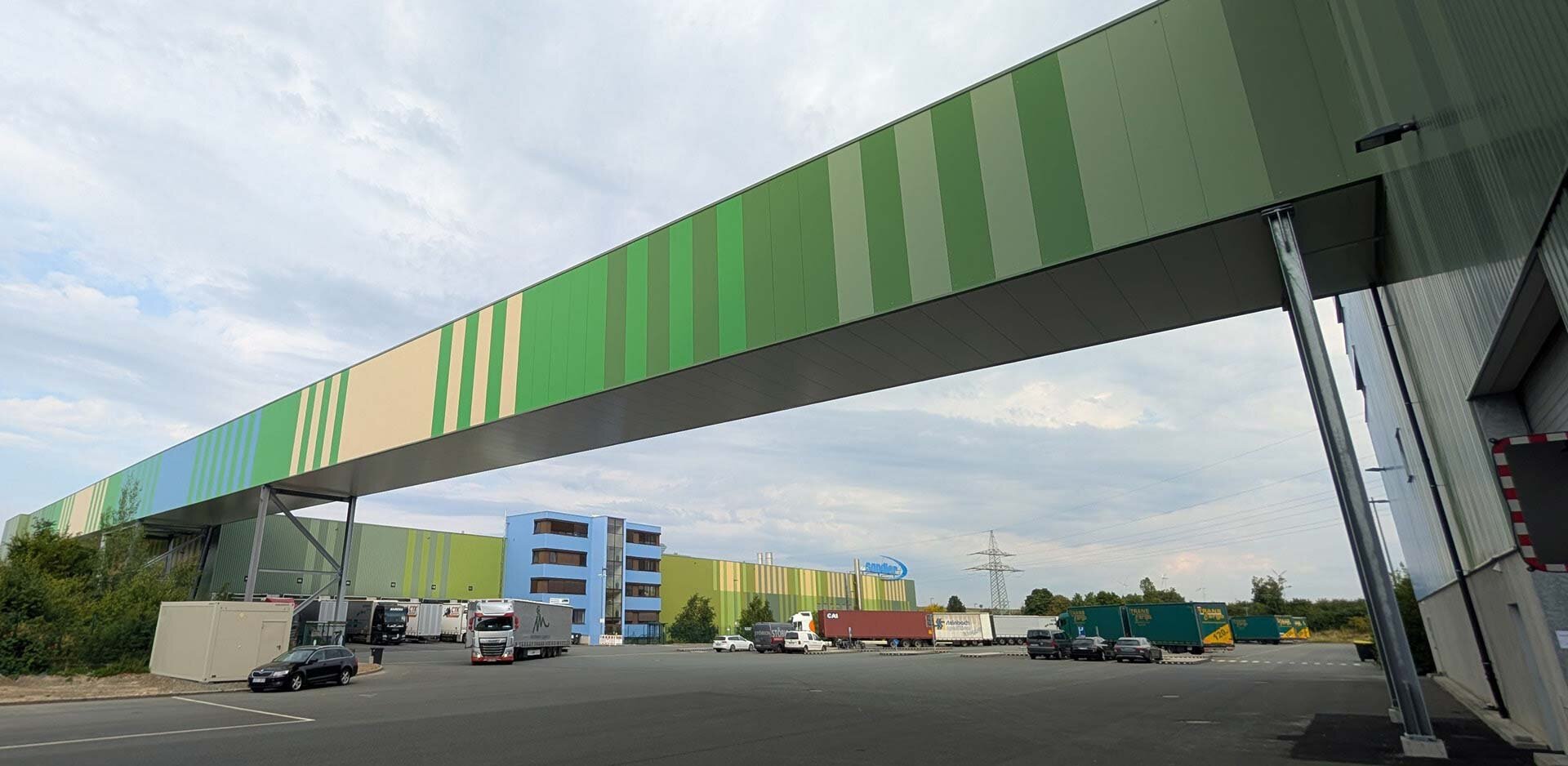 A striped bridge crossing over a street