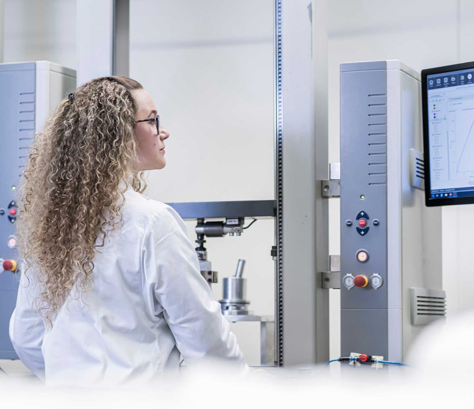Woman from Research & Development at Sandler looks at the screen of a laboratory device